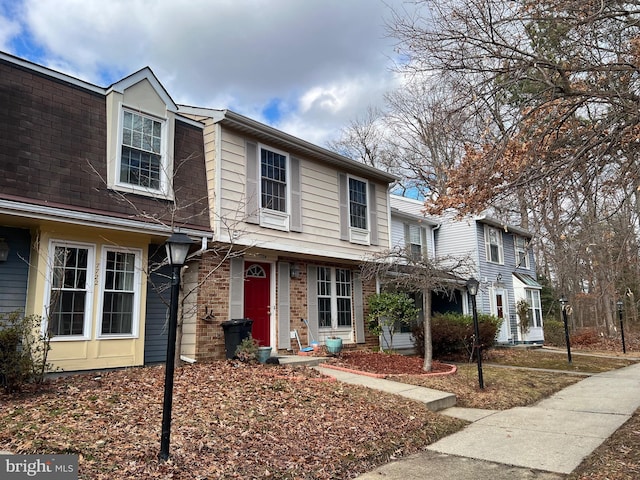 townhome / multi-family property with brick siding