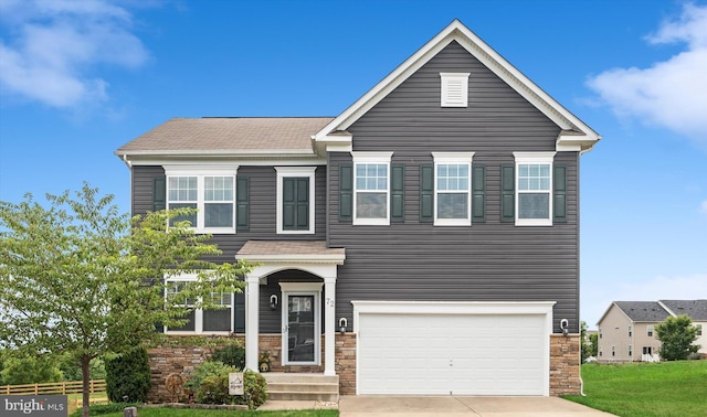 traditional-style home featuring an attached garage, stone siding, concrete driveway, and a front yard