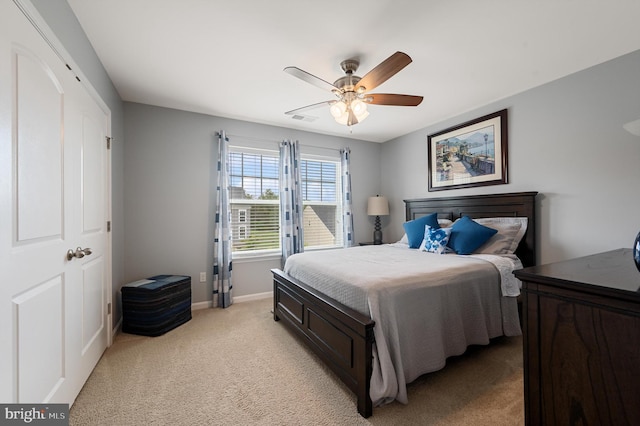 bedroom with ceiling fan, baseboards, and light colored carpet