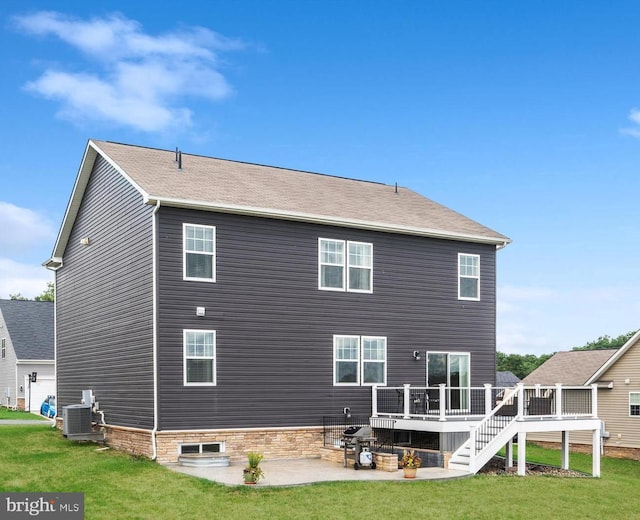 back of property with a deck, cooling unit, stairs, a yard, and a patio area