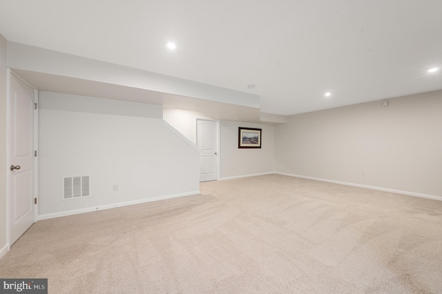 finished basement with light carpet, baseboards, visible vents, and recessed lighting