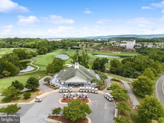 birds eye view of property featuring view of golf course and a water view