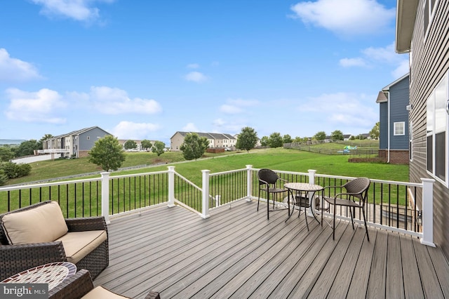 wooden deck featuring a yard