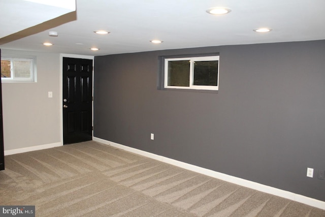 below grade area with carpet floors, recessed lighting, and baseboards