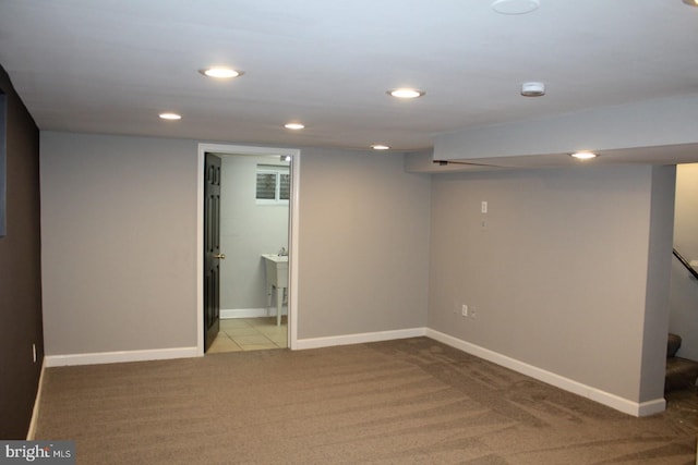 finished basement featuring carpet, stairs, baseboards, and recessed lighting