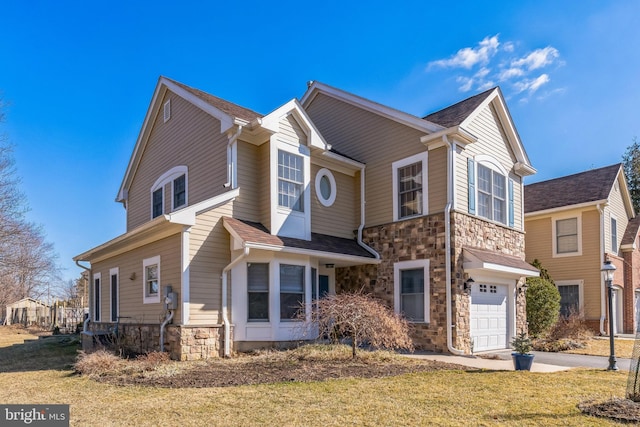 view of front of home with stone siding, concrete driveway, a front lawn, and an attached garage