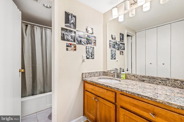 bathroom featuring tile patterned flooring, shower / bath combo with shower curtain, and vanity