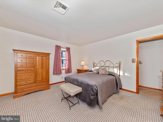 bedroom featuring baseboards, visible vents, and light colored carpet