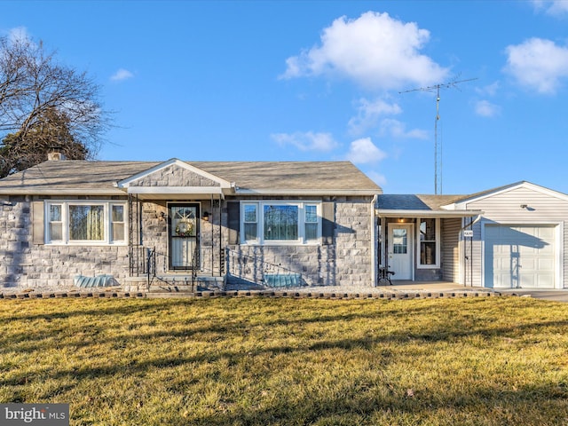 view of front of house featuring stone siding, roof with shingles, an attached garage, and a front lawn