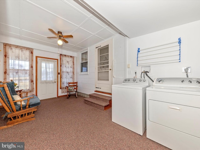 clothes washing area featuring light carpet, ceiling fan, and washing machine and clothes dryer