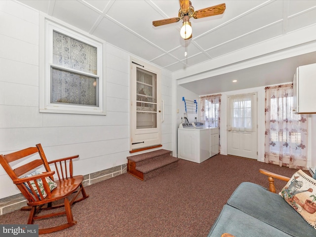 sitting room featuring ceiling fan, carpet floors, and washing machine and dryer