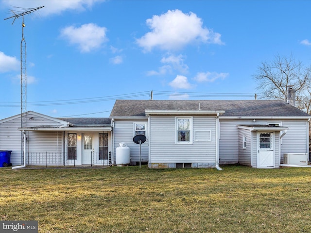 rear view of house with roof with shingles, a yard, a chimney, and central AC unit