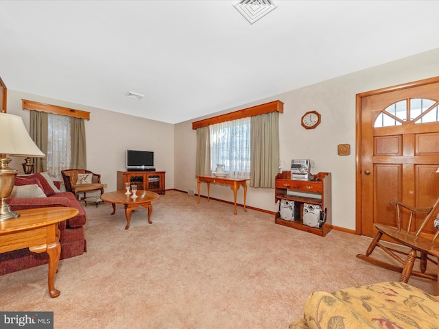 carpeted living area with visible vents and baseboards