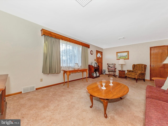 living room with carpet floors, baseboards, and visible vents