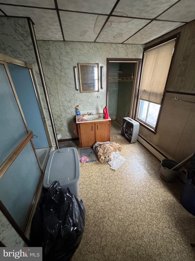 interior space with a baseboard radiator and a sink