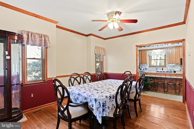 20 Glade Ave, Baltimore, MD 21236 - dining space featuring light wood-style flooring, a ceiling fan, and crown molding