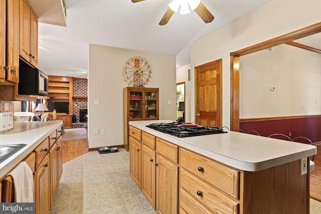 20 Glade Ave, Baltimore, MD 21236 - kitchen featuring gas cooktop, ceiling fan, light countertops, and a fireplace