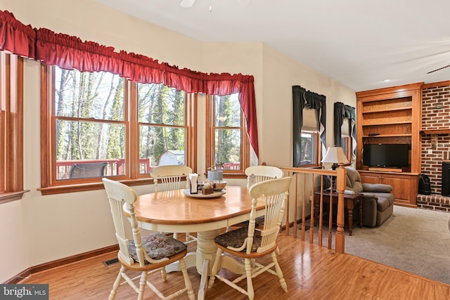 20 Glade Ave, Baltimore, MD 21236 - dining area featuring built in features, baseboards, ceiling fan, wood finished floors, and a brick fireplace