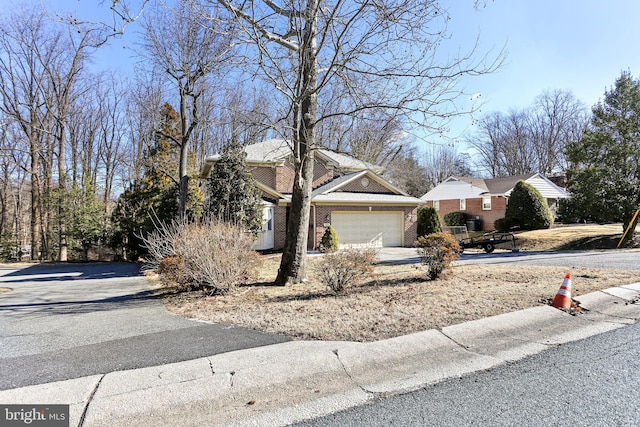 20 Glade Ave, Baltimore, MD 21236 - view of front of home with asphalt driveway, an attached garage, and brick siding