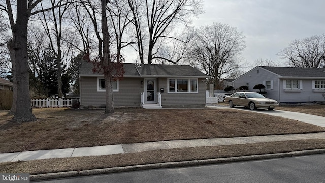 single story home with fence