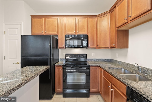 8610 Liberty Trl Unit 102, Manassas, VA 20110 - kitchen with dark stone counters, brown cabinets, a sink, and black appliances