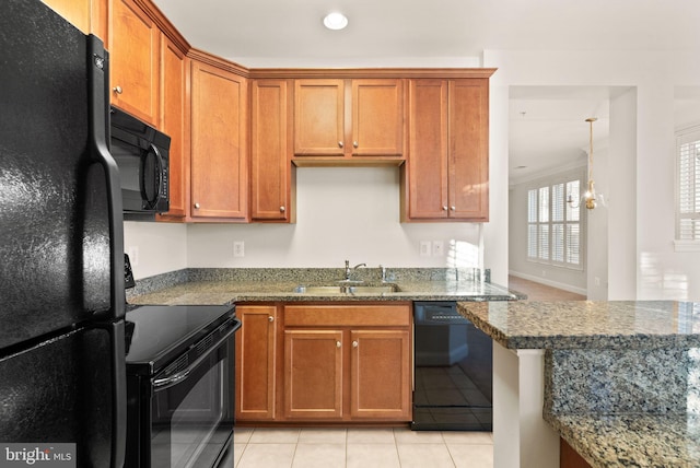 8610 Liberty Trl Unit 102, Manassas, VA 20110 - kitchen featuring black appliances, stone counters, brown cabinets, and a sink