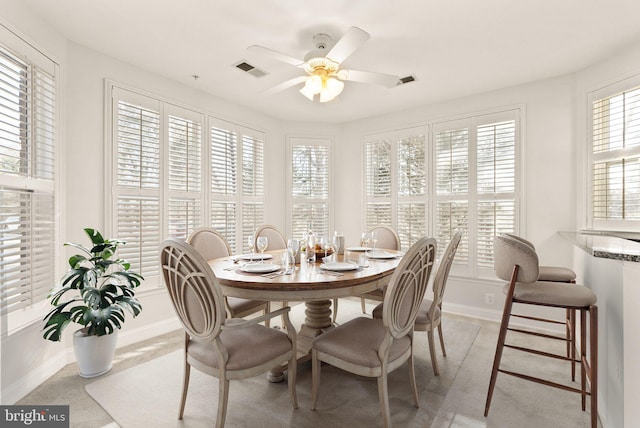 8610 Liberty Trl Unit 102, Manassas, VA 20110 - dining area featuring ceiling fan, light carpet, visible vents, and baseboards