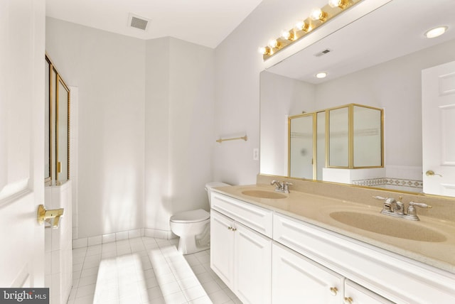 8610 Liberty Trl Unit 102, Manassas, VA 20110 - bathroom with a shower with shower door, visible vents, a sink, and tile patterned floors