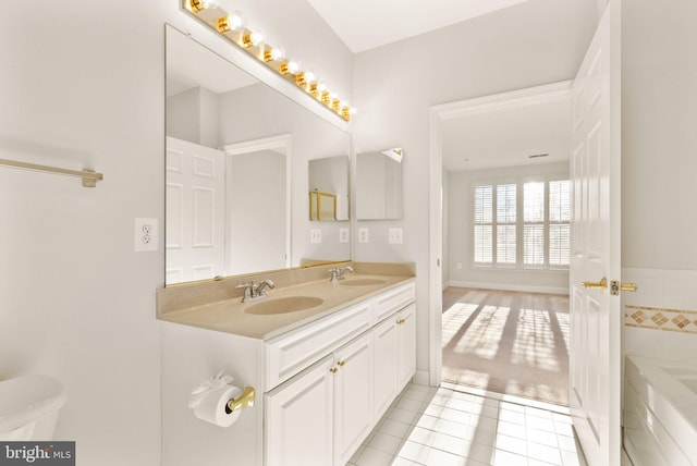 8610 Liberty Trl Unit 102, Manassas, VA 20110 - bathroom with a tub to relax in, tile patterned flooring, a sink, and double vanity