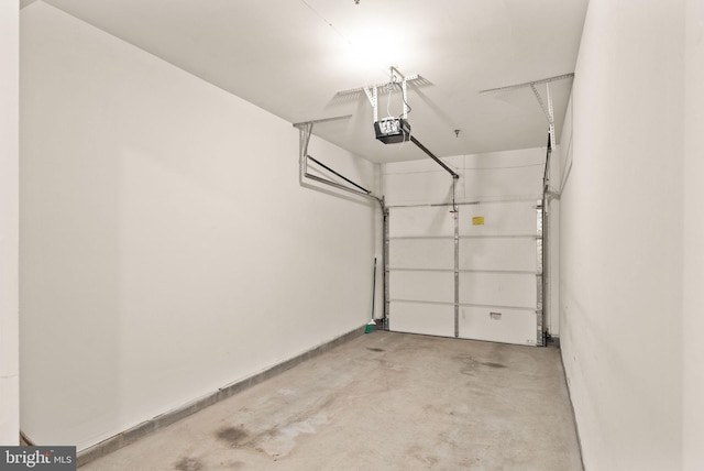 8610 Liberty Trl Unit 102, Manassas, VA 20110 - garage featuring baseboards and a garage door opener