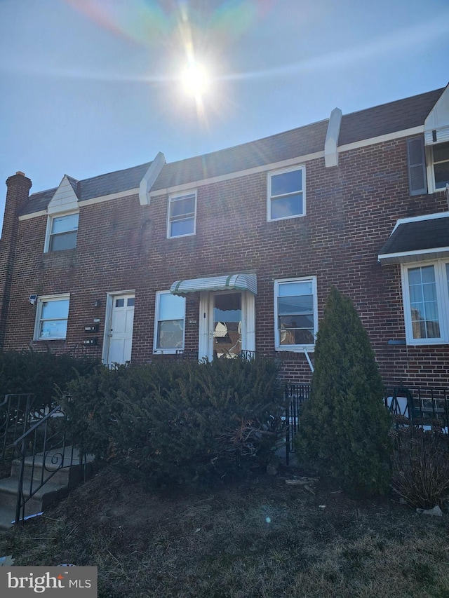 view of property with brick siding