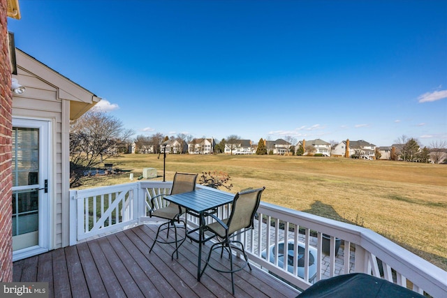 deck featuring a lawn and a residential view