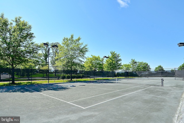 view of tennis court with fence