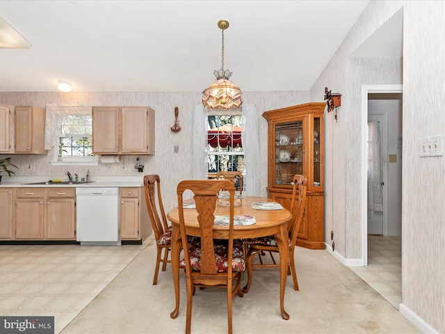 dining area featuring wallpapered walls and light floors