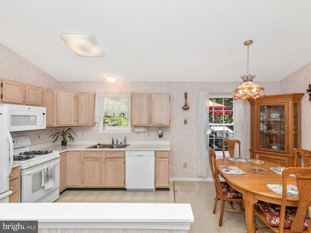 kitchen with white appliances, light brown cabinets, and wallpapered walls