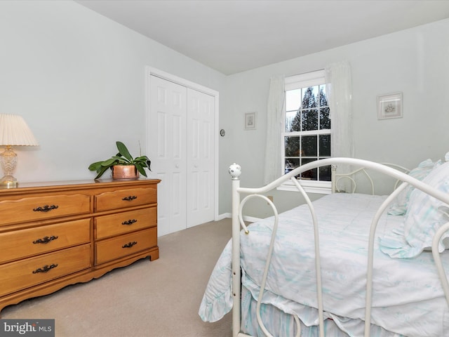 bedroom featuring light carpet and a closet