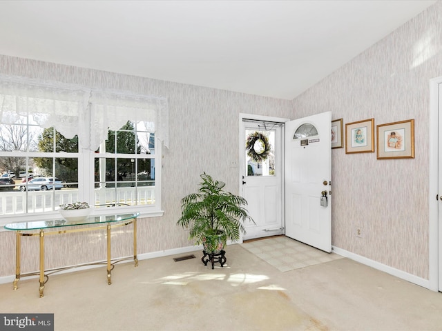 foyer entrance featuring tile patterned floors, visible vents, baseboards, and wallpapered walls