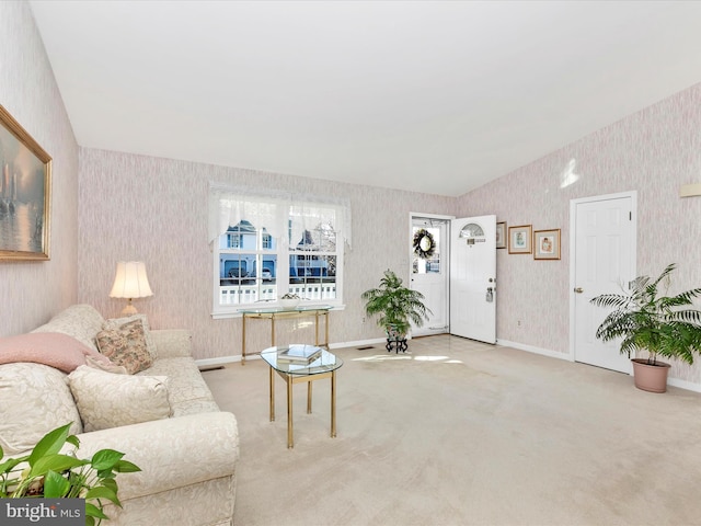 living room with baseboards, carpet floors, vaulted ceiling, and wallpapered walls