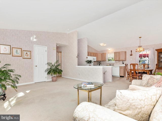 living area featuring lofted ceiling, light colored carpet, an inviting chandelier, baseboards, and wallpapered walls