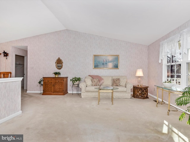 living room with lofted ceiling, carpet flooring, baseboards, and wallpapered walls