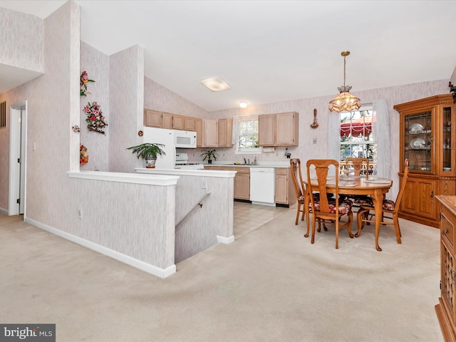 kitchen featuring light carpet, white appliances, vaulted ceiling, light countertops, and wallpapered walls