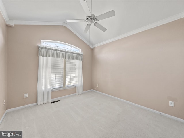 spare room with light colored carpet, visible vents, baseboards, vaulted ceiling, and ornamental molding