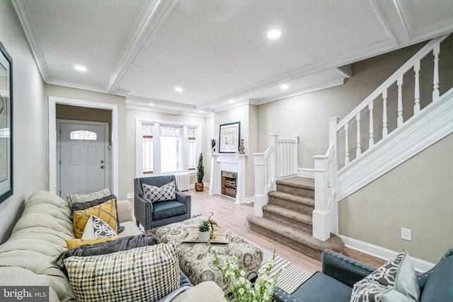 living area featuring stairs, recessed lighting, wood finished floors, and crown molding