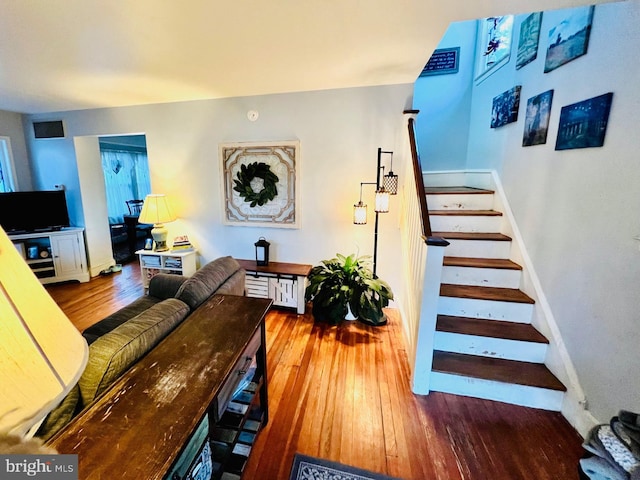 stairway with baseboards and wood finished floors