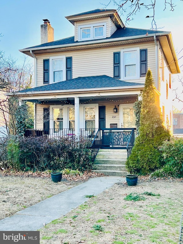 traditional style home with a chimney and a porch