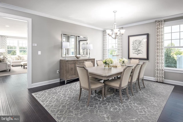 dining space with dark wood-style floors, a chandelier, crown molding, and baseboards