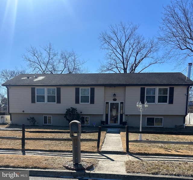 split foyer home featuring a fenced front yard