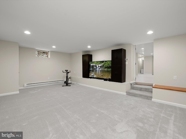 exercise room with a baseboard heating unit, light carpet, and recessed lighting