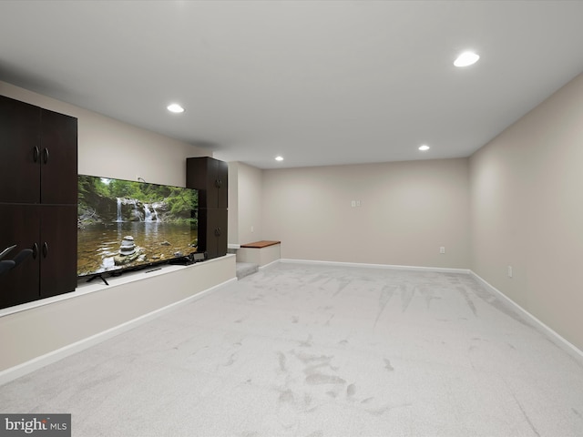 below grade area with recessed lighting, baseboards, and light colored carpet