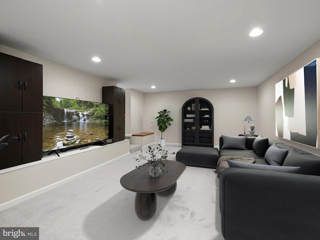 living area with recessed lighting, baseboards, and light carpet